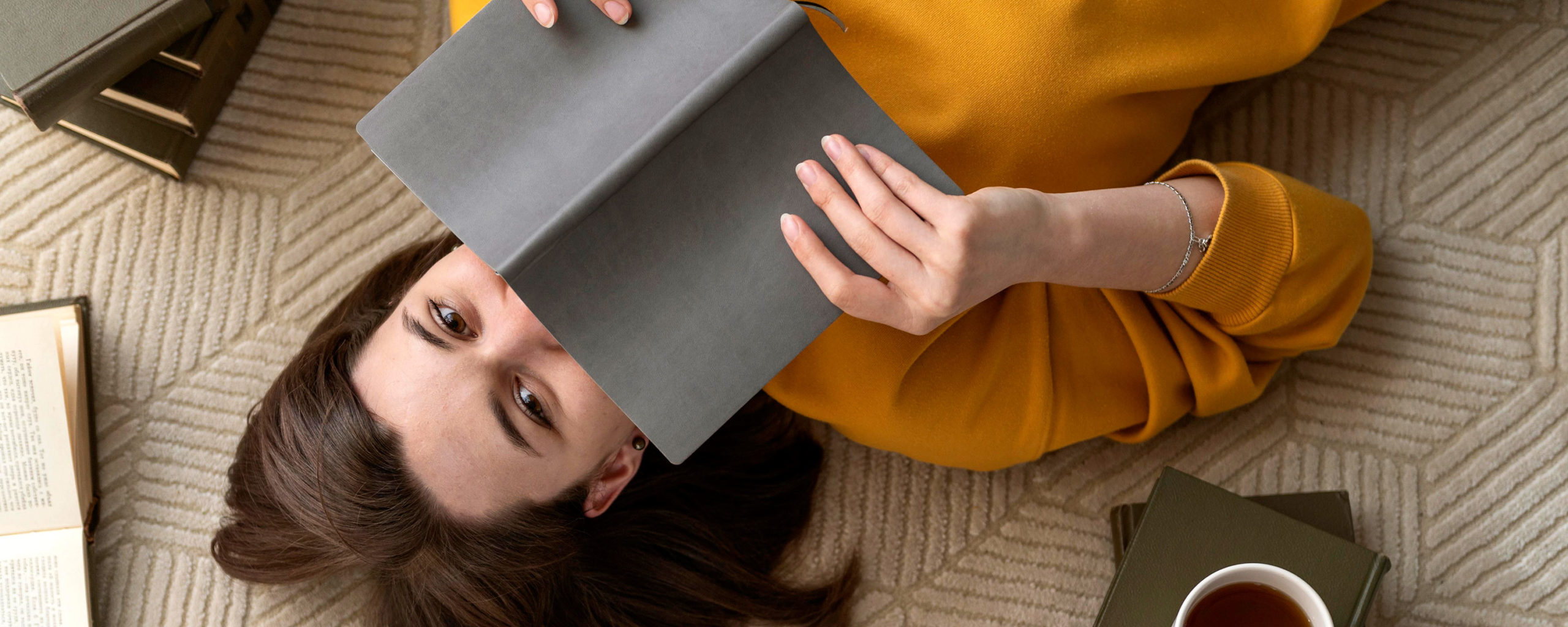 top view of woman reading book