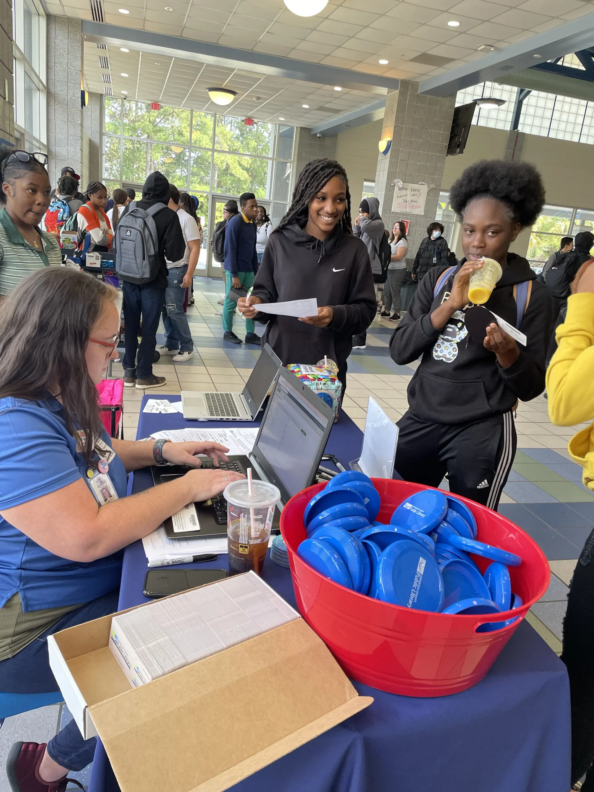 Teens signing up for library cards at Airport High School