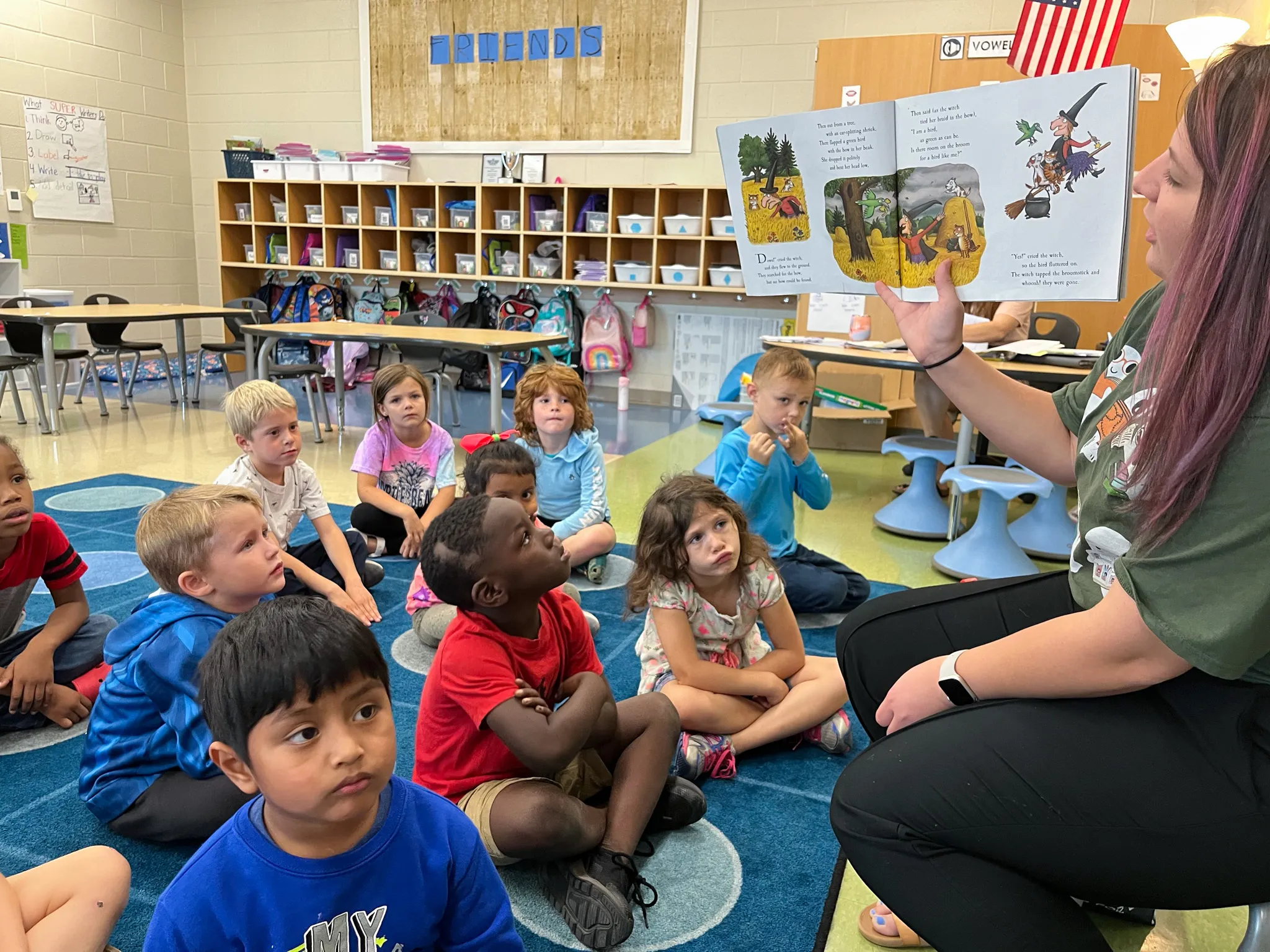 Library staff member reading book to group of kids at Gilbert elementary school