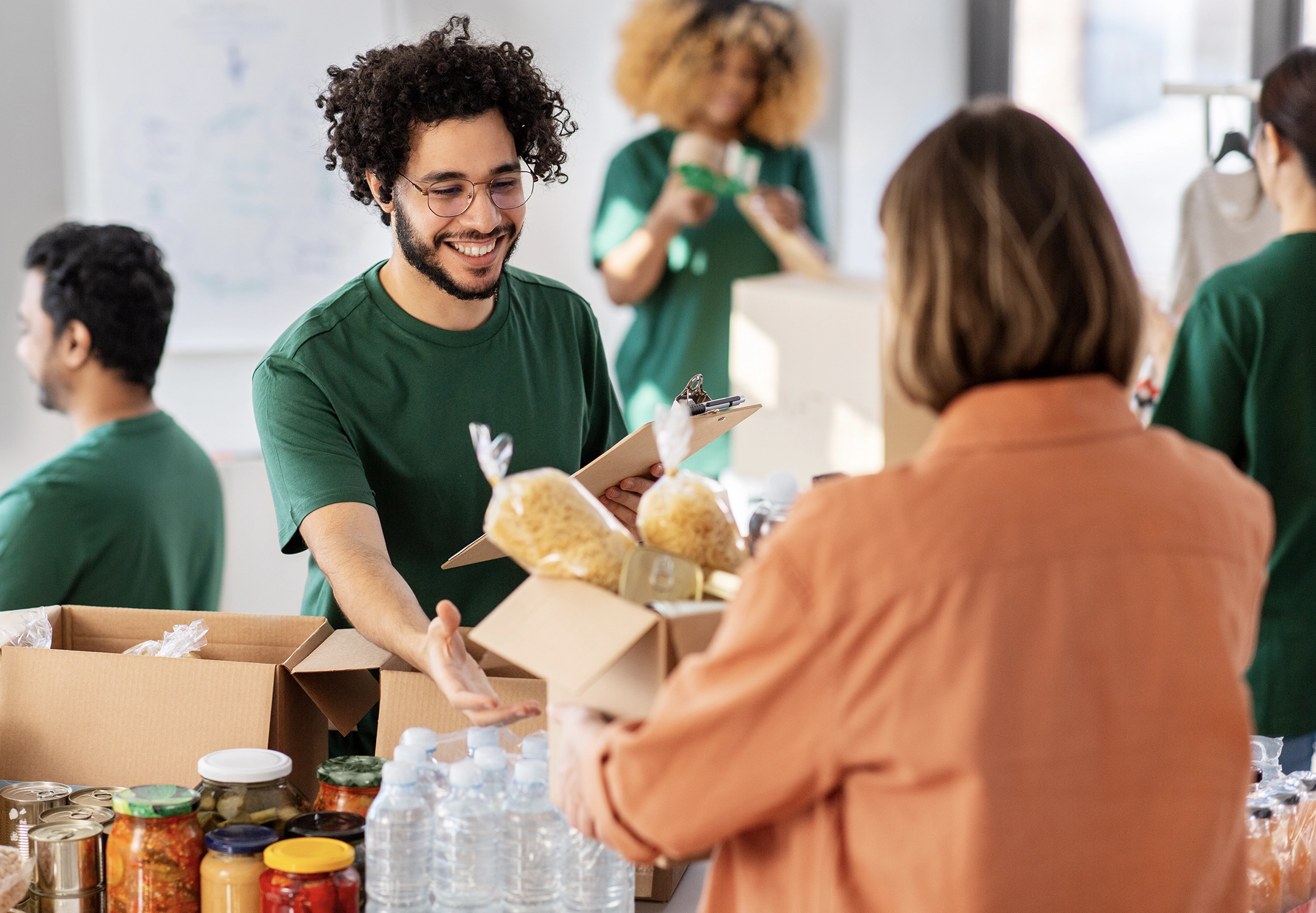 volunteers packing food in donation boxes
