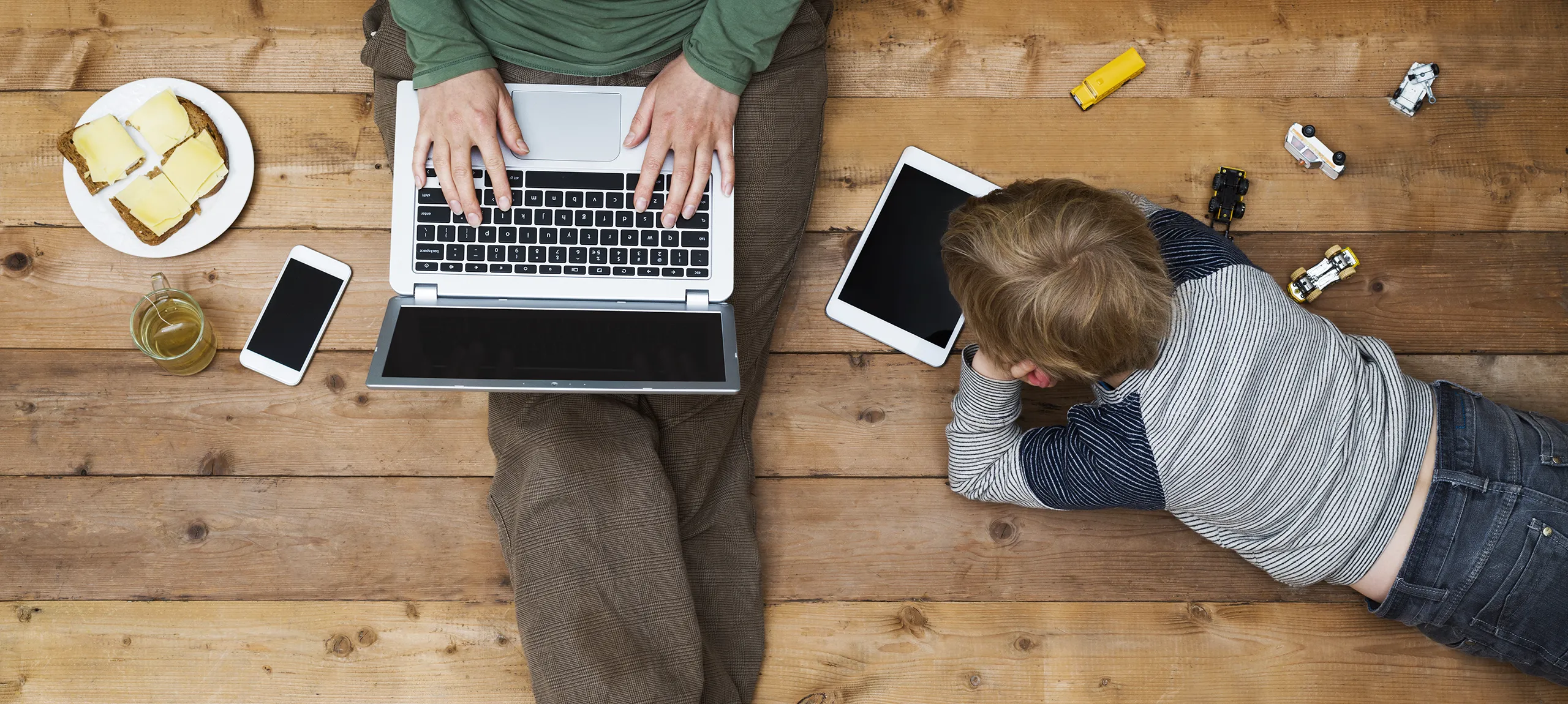 mom using laptop, son on iPad