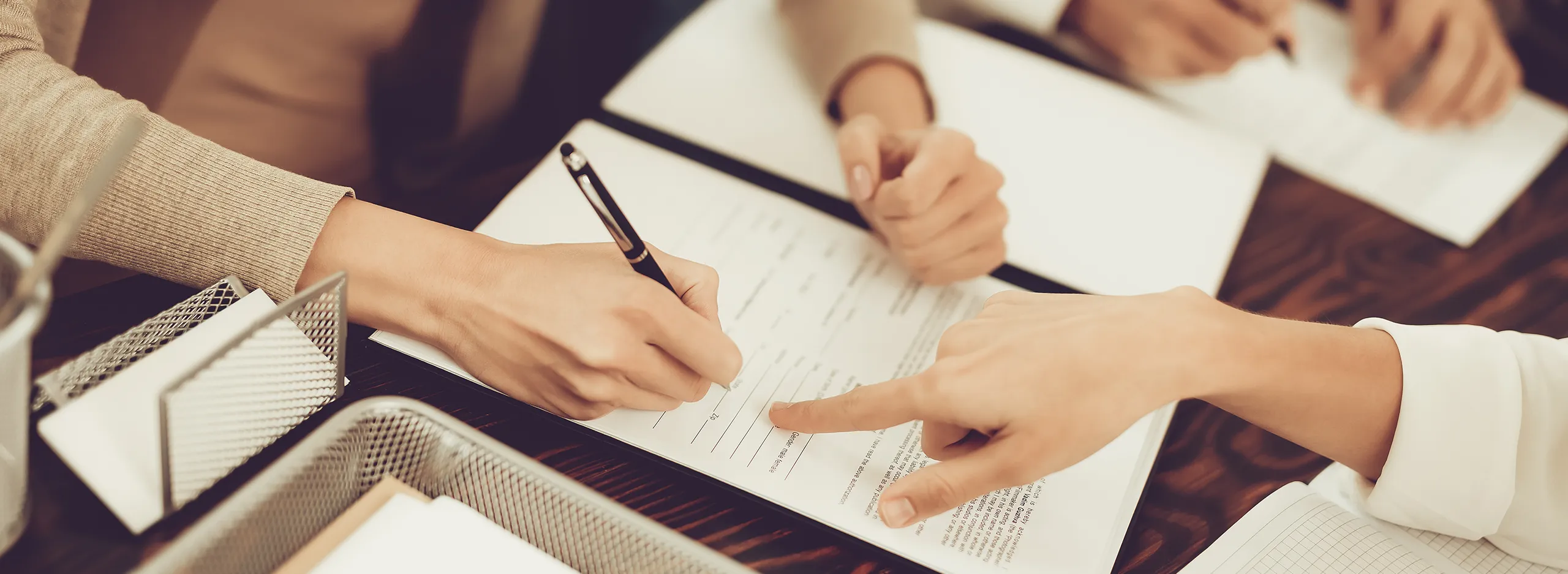 people signing documents